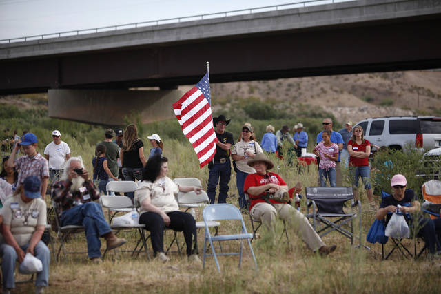 People gather along the Virgin River during a rally in support of Cliven Bundy near Bunkerville on Friday, April 18, 2014. (John Locher/Las Vegas Review-Journal)