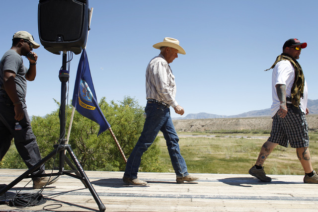 Rancher Cliven Bundy, center, walks on stage to speak at a press conference near Bunkerville, Nev. Thursday, April 24, 2014. (John Locher/Las Vegas Review-Journal)