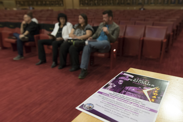 A flyer with information about the city's street performer portal sits on a wall during a meeting to discuss new rules for downtown buskers during a meeting at Las Vegas City Hall Council Chambers ...