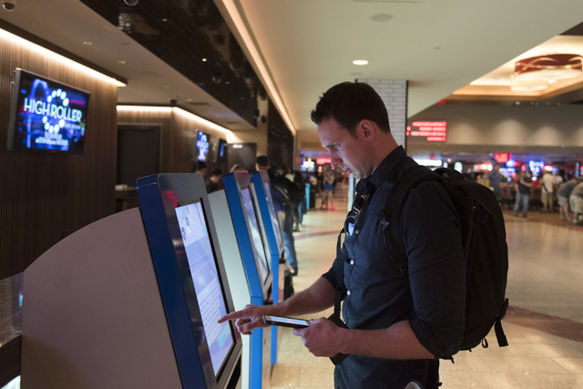 Austin Dillman of San Francisco uses one of the seven new self check-in kiosks located in the lobby at The Linq Hotel in Las Vegas Wednesday, March 16, 2016. Jason Ogulnik/Las Vegas Review-Journal