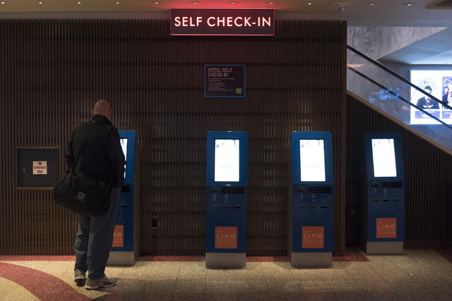 A man uses one of the seven new self check-in kiosks located in the lobby at The Linq Hotel in Las Vegas Wednesday, March 16, 2016. Jason Ogulnik/Las Vegas Review-Journal