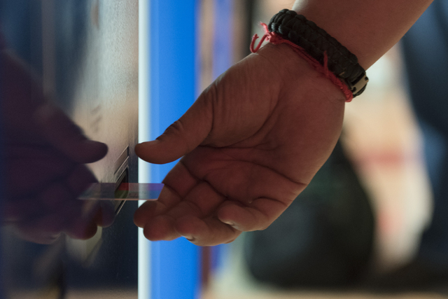 Ray L. Perez of Austin, Texas, retrieves his room key one of the seven new self check-in kiosks located in the lobby at The Linq Hotel in Las Vegas Wednesday, March 16, 2016. Jason Ogulnik/Las Veg ...
