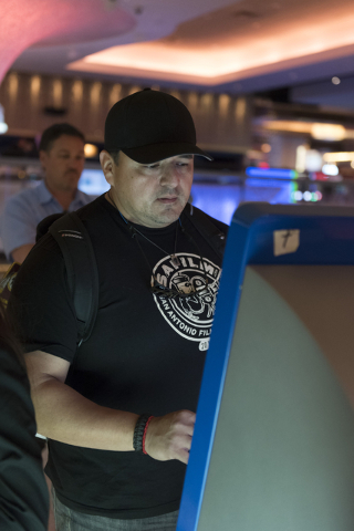 Ray L. Perez of Austin, Texas, uses one of the seven new self check-in kiosks located in the lobby at The Linq Hotel in Las Vegas Wednesday, March 16, 2016. Jason Ogulnik/Las Vegas Review-Journal