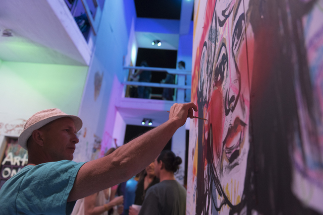 Curtis Sill paints during the illumination ceremony for the Life Cube in the Llama Lot at Fremont Street and 9th Street in Las Vegas Saturday, March 19, 2016. The ceremony kicks off two weeks of c ...