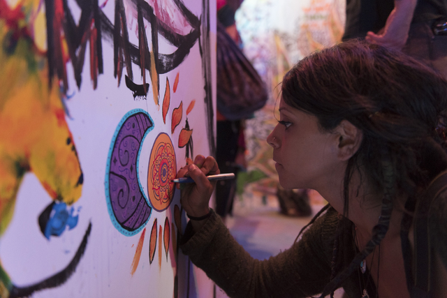 Ali Pullen paints during the illumination ceremony for the Life Cube in the Llama Lot at Fremont Street and 9th Street in Las Vegas Saturday, March 19, 2016. The ceremony kicks off two weeks of cu ...