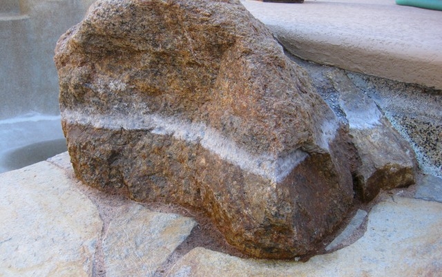 PHOTO BY MARY VAIL
The prominent calcium deposits on the boulder is a telltale sign it is time to drain the pool.