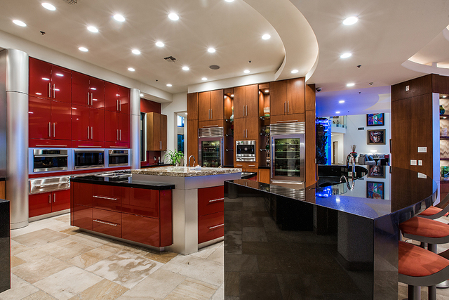 (COURTESY OF Shapiro & Sher Group)  
The kitchen is dressed in deep reds and has upgraded appliances.
