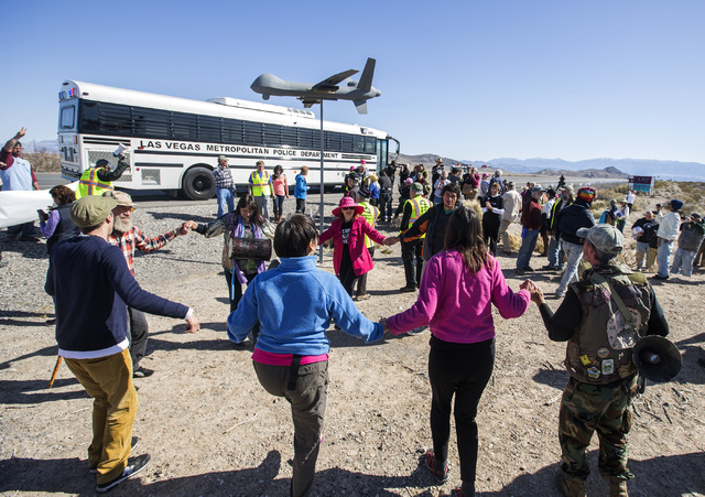 Anti-drone warfare protesters dance after being release by Las Vegas police across the street from  Creech Air Force Base at Indian Springs on Friday, March 6, 2015. Thirty-three protesters were c ...