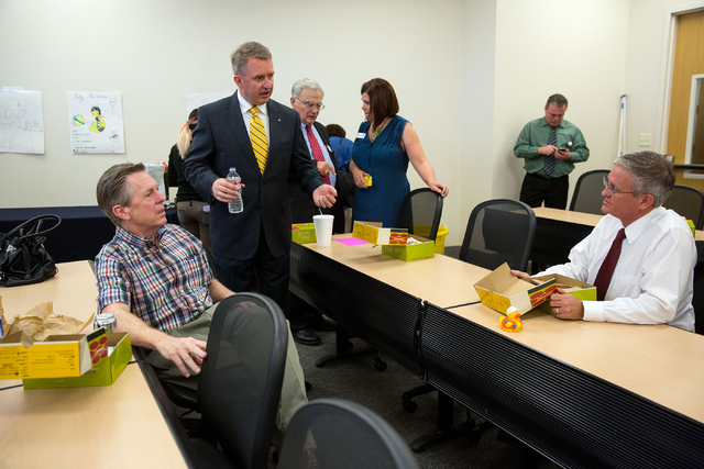 Maurice Gallagher, CEO of Allegiant Travel Co., left, Paul Moffat, second from left, and Marcus Johnson, dean of College of Southern Nevada School of Business, far right, talk during a luncheon at ...