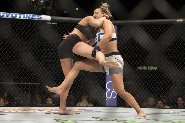 Holly Holm, left, battles against Miesha Tate in their women’s bantamweight title bout during UFC 196 at MGM Grand Garden ArenaSaturday, March 5, 2016, in Las Vegas. Tate won by way of subm ...