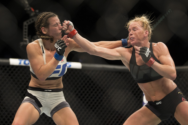 Miesha Tate, left, battles against Holly Holm in their women’s bantamweight title bout during UFC 196 at MGM Grand Garden ArenaSaturday, March 5, 2016, in Las Vegas. Tate won by way of subm ...