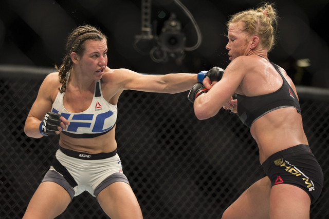 Miesha Tate, left, connects a left punch against Holly Holm in their women’s bantamweight title bout during UFC 196 at MGM Grand Garden ArenaSaturday, March 5, 2016, in Las Vegas. Tate won  ...