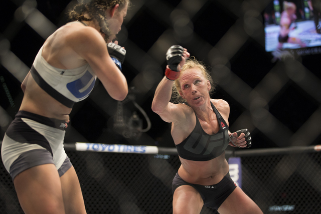 Miesha Tate, left, moves away from a punch against Holly Holm in their women’s bantamweight title bout during UFC 196 at MGM Grand Garden ArenaSaturday, March 5, 2016, in Las Vegas. Tate wo ...