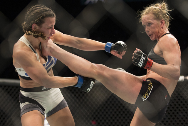 Holly Holm, right, connects a kick against Miesha Tate in their women’s bantamweight title bout during UFC 196 at MGM Grand Garden ArenaSaturday, March 5, 2016, in Las Vegas. Tate won by wa ...