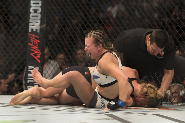 Miesha Tate, left, reacts to her victory against Holly Holm by way of submission in their women’s bantamweight title bout during UFC 196 at MGM Grand Garden ArenaSaturday, March 5, 2016, in ...