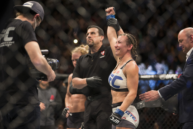 Miesha Tate, right, reacts to her victory against Holly Holm by way of submission in their women’s bantamweight title bout during UFC 196 at MGM Grand Garden ArenaSaturday, March 5, 2016, i ...