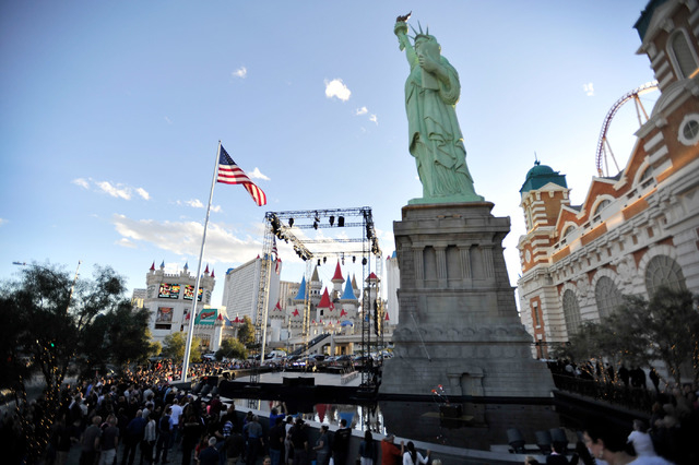 Tourists watch a Cirque du Soleil preview performance in front of the New York New York hotel-casino in Las Vegas on Thursday, Feb. 26, 2015. (David Becker/Las Vegas Review-Journal)