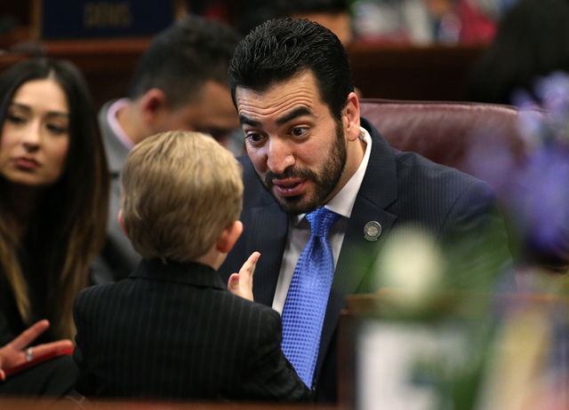Nevada Sen. Ruben Kihuen, D-Las Vegas, plays with Sen. Ben Kieckhefer's son Lincoln, 5, during opening day ceremonies at the Legislative Building in Carson City, Nev., on Monday, Feb. 2, 2015. (Ca ...