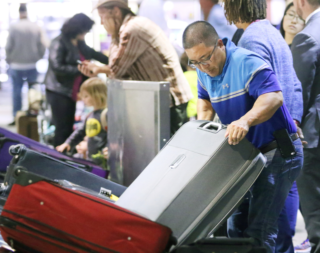 Mits Ohata, of Stockton, Calif., retrieves luggage at a Southwest Airlines baggage claim at McCarran International Airport Wednesday, March 23, 2016, in Las Vegas. Ronda Churchill/Las Vegas Review ...