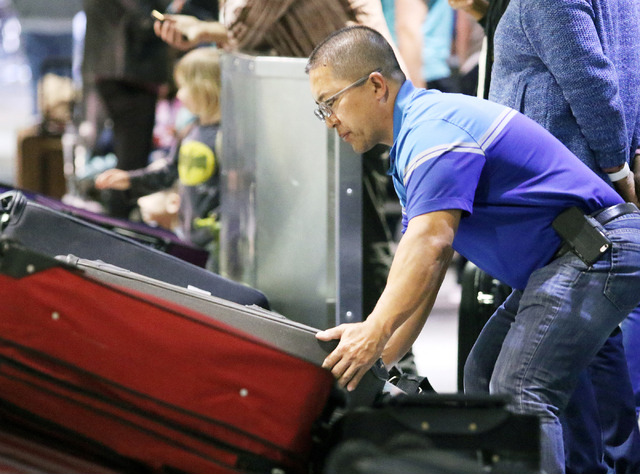 Mits Ohata, of Stockton, Calif., retrieves luggage at a Southwest Airlines baggage claim at McCarran International Airport Wednesday, March 23, 2016, in Las Vegas. Ronda Churchill/Las Vegas Review ...