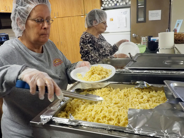 Sue Mayer, left, and Patti Moyer serve lunch for seniors at the Holy Spirit Lutheran Church March 2. Jerry Henkel/View