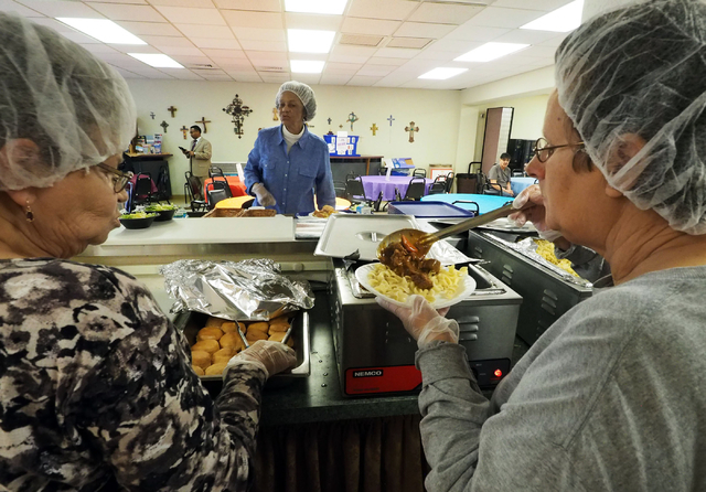 Patti Moyer, left, and Sue Mayer, right, dish up beef stew while Alberta Raggs, center, serves the lunch for seniors at the Holy Spirit Lutheran Church March 2. Jerry Henkel/View