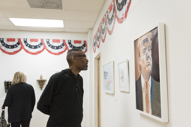 Kenn Ruffin views the "MUG SHOTS #3" group show at Left of Center Art Gallery March 12. Jason Ogulnik/View
