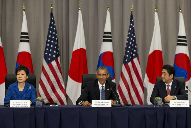 President Barack Obama meets with South Korean President Park Geun-hye, left, and Japanese Prime Minister Shinzo Abe during the Nuclear Security Summit in Washington, Thursday, March 31, 2016. (AP ...