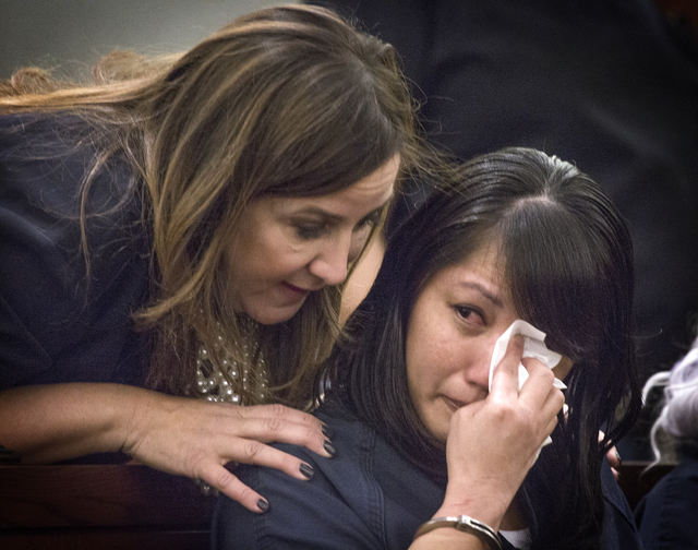 Michelle Paet cries while her attorney Kristina Wildeveld talks to her during her sentencing at Regional Justice Center on Thursday, March 3, 2016. She received life in prison for killing her husb ...