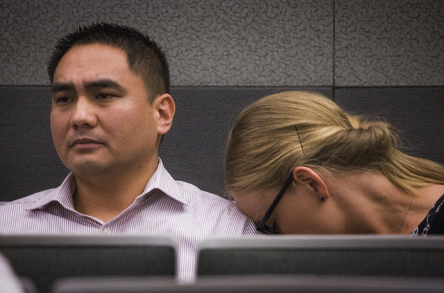 Eric Paet, left, sits while his wife Veronica Carlson-Paet cries on his shoulder during the sentencing of his sister-in-law Michelle Paet  at Regional Justice Center on Thursday, March 3, 2016. Mi ...