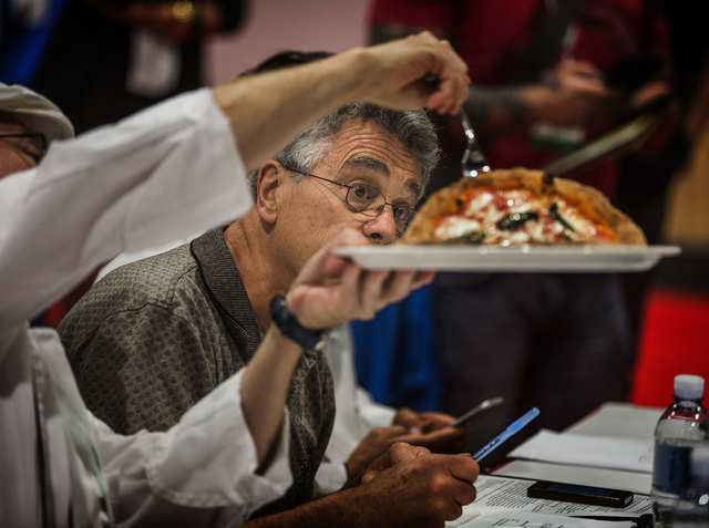 Raymond Bar looks at a pizza crust while judge the Napoletana division competition during the Pizza Expo at  the Las Vegas Convention Center on Tuesday, March 8, 2016. Jeff Scheid/Las Vegas Review ...