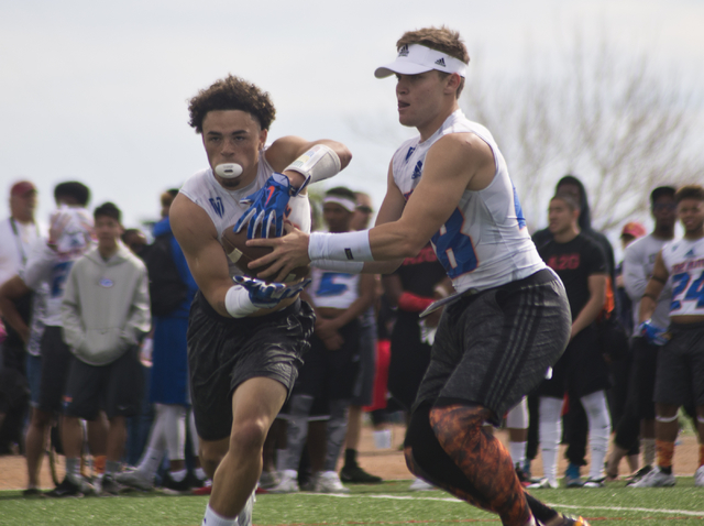 702 Elite's Tate Martell (18) hands the ball off to Ethan Dedeaux (2) during their game against TNT during the Pylon Elite 7v7 Las Vegas National football tournament at All American Park in Las Ve ...