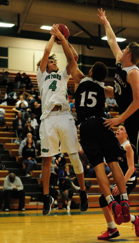 Green Valley guard Xavier Jarvis (4) goes up for a shot against Coronado forward Kennedy Koe ...
