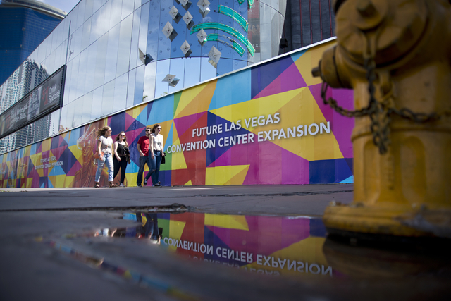 Pedestrians walk by advertising for the expansion of the Las Vegas Convention Center outside the shuttered Riviera hotel-casino on the Las Vegas Strip on Tuesday, March 29, 2016. Daniel Clark/Las  ...