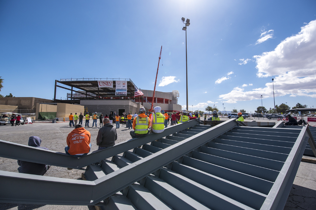 Construction workers look on during the Thomas & Mack topping-off ceremony at UNLV in Las Vegas on Tuesday, March 22, 2016. Joshua Dahl/Las Vegas Review-Journal