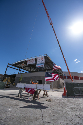 Construction workers raise the steel beam into place during the Thomas & Mack topping-off ceremony at UNLV in Las Vegas on Tuesday, March 22, 2016. Joshua Dahl/Las Vegas Review-Journal