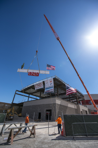Construction workers raise the steel beam into place during the Thomas & Mack topping-off ceremony at UNLV in Las Vegas on Tuesday, March 22, 2016. Joshua Dahl/Las Vegas Review-Journal