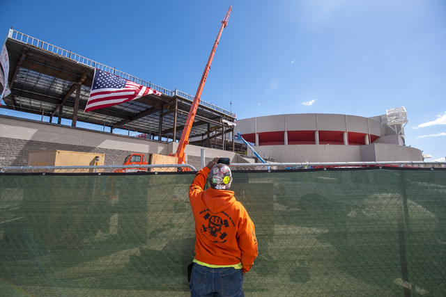 Gerald Wilson records a video on his phone as workers raise the steel beam into place during the Thomas & Mack topping-off ceremony at UNLV in Las Vegas on Tuesday, March 22, 2016. Joshua Dahl ...