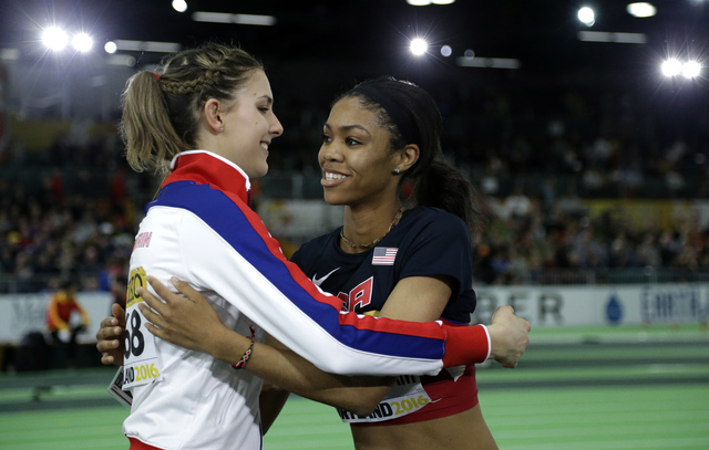 United States' Vashti Cunningham, right, is hugged by Britain's Isobel Pooley after Cunningham won the women's high jump final during the World Indoor Athletics Championships, Sunday, March 20, 20 ...