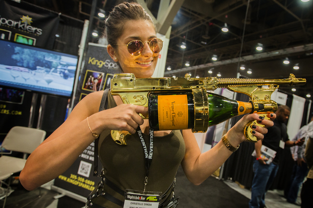 Christelle Candia holds the King of Sparkers champagne spray gun at the Nightclub & Bar Convention & Trade Show in the Las Vegas Convention Center on Tuesday,  March 8, 2016. Jeff Scheid/L ...