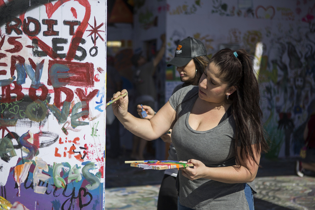 Liza Rivera paints the Life Cube Project structure at the intersection of 9th Street and Fremont Street on Friday, March 25, 2016, in Las Vegas. Erik Verduzco/Las Vegas Review-Journal Follow @Erik ...