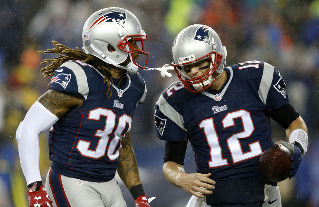 Jan 18, 2015; Foxborough, MA, USA; New England Patriots quarterback Tom Brady (12) celebrates with running back Brandon Bolden (38) after throwing a touchdown pass during the third quarter against ...
