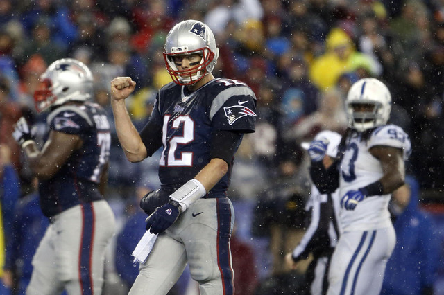 Jan 18, 2015; Foxborough, MA, USA; New England Patriots quarterback Tom Brady (12) pumps his fist as he heads up to the line against the Indianapolis Colts in the second half in the AFC Championsh ...
