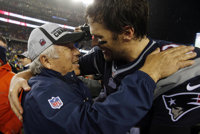 New England Patriots owner Robert Kraft, left, greets quarterback Tom Brady (12) after the AFC Championship Game against the Indianapolis Colts at Gillette Stadium on Jan 18, 2015. (David Butler I ...