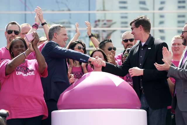 MGM Resorts International President and Chief Executive Officer Jim Murren and T-Mobile Chief Marketing Officer Andrew Sherrard shake hands during the grand opening of MGM Resorts  International's ...