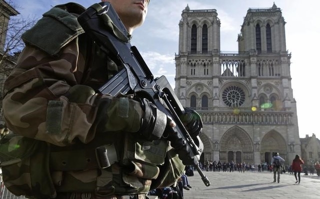 An armed French soldier patrols in front of Notre Dame Cathedral in Paris on Dec. 24, 2015. (Philippe Wojazer/Reuters)