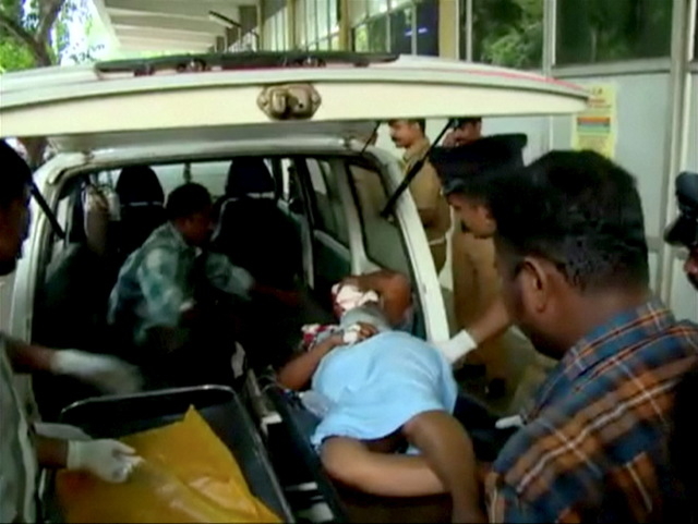 An injured person is attended to at a hospital, after a fire broke out as people gathered for a fireworks display at a temple in Kollam, southern India, in this still image taken from video April  ...