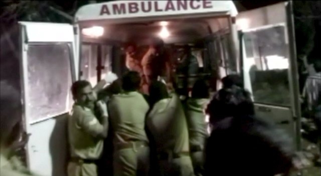 Police rush injured into an ambulance after a fire broke out as people gathered for a fireworks display at a temple in Kollam, southern India, in this still image taken from video April 10, 2016.  ...