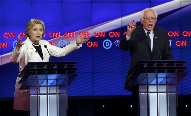 Hillary Clinton and Bernie Sanders speak simultaneously during a Democratic debate on April 14, 2016. (Lucas Jackson/Reuters)