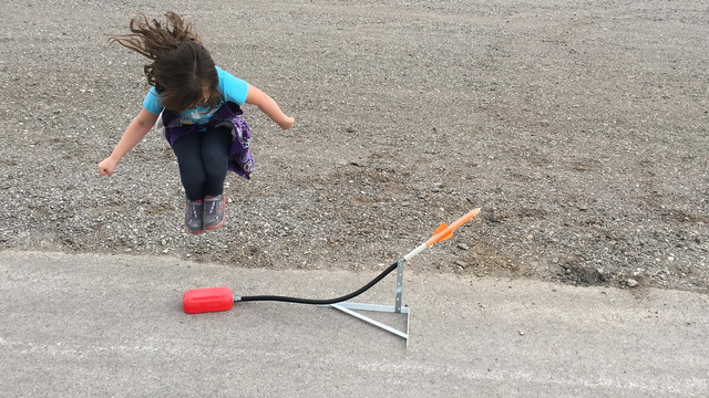 A young girl jumps to launch her rocket during a science of rockets session put on by the University of Nevada Cooperative Extension at the SkyView YMCA, 3050 E. Centennial Parkway, on March 21, 2 ...